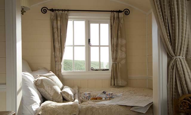 Make your bedroom look bigger like this Farmhouse bedroom by Riverside Shepherd Huts Ltd.