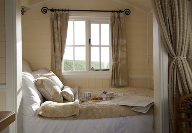 Make your bedroom look bigger like this Farmhouse bedroom by Riverside Shepherd Huts Ltd.