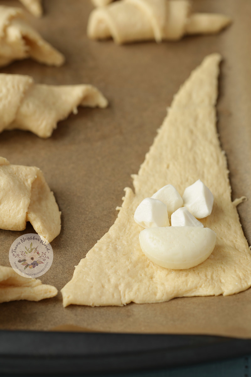 Before you roll them up, you lay out the cheeses.